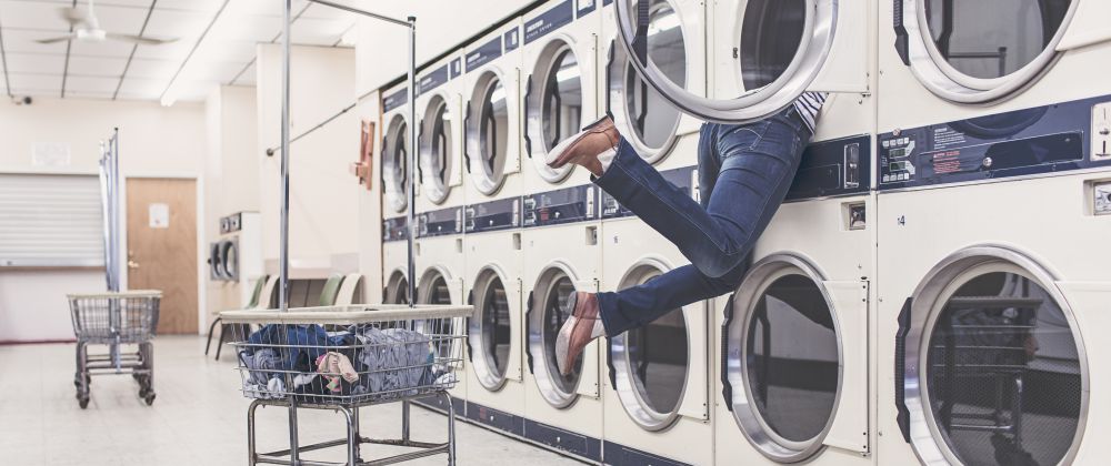 lady's legs hanging out of washing machine
